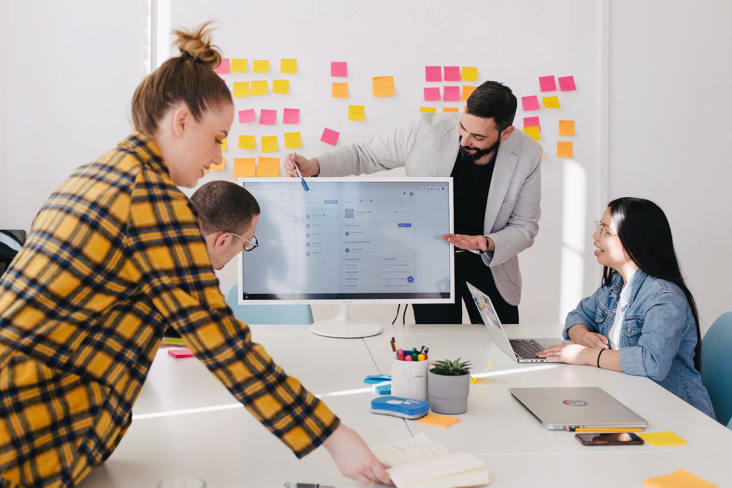 A discovery workshop: a team mapping a user journey in front of a wall of sticky notes.